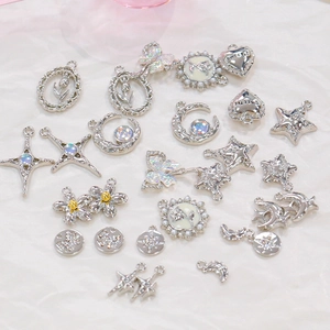 Detailed view of silver DIY pendants with moon, star, and tulip shapes with pearls