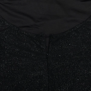 Close-up of invisible zipper and sparkling silver sequins on back of black dress