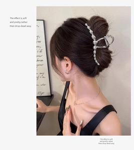Elegant silver metal hair claw clip with ball design shown on model for back-of-head styling