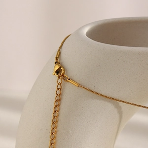Detail of 18K gold-plated stainless steel necklace with a secure lobster clasp closure