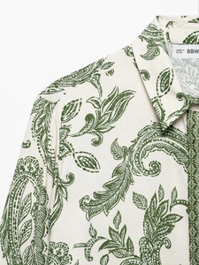 Close-up of vintage green paisley pattern on a beige cotton-linen shirt collar