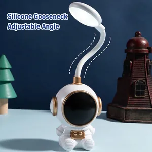 Astronaut LED desk lamp with flexible white silicone hose and gold details for reading