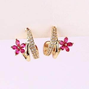 Elegant gold earrings with pavé cubic zirconia and red gem flower detail
