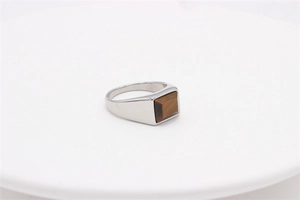 Detail of square brown tiger eye stone set in a minimalist silver titanium steel ring