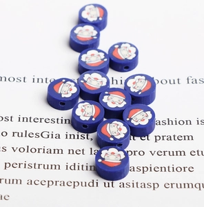 Close-up of blue polymer clay Christmas Santa beads for DIY jewelry and crafts making