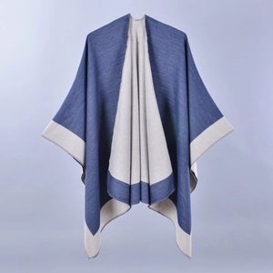 Detail view of two-tone blue and grey split poncho cape with soft knitted texture