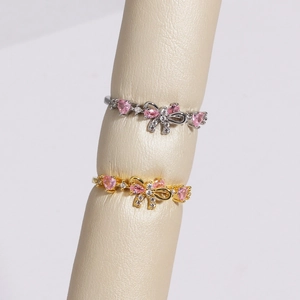 Adjustable bow ring set in gold and silver with pink heart crystal and white rhinestones