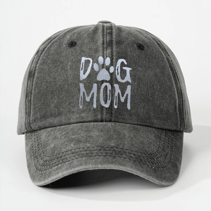Close-up of washed cotton texture and DOG MOM embroidery on the dark grey baseball cap