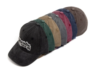 Close-up of washed cotton baseball caps in multiple retro colors with Florida embroidery