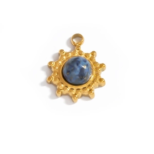 Detail of a vintage golden starburst pendant with a deep blue marble stone inlay