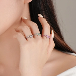 Elegant S925 silver bow rings with micro-set zircon in silver, green, and pink colors