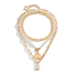 Detail of layered Baroque pearl necklace with gold coin and padlock pendants