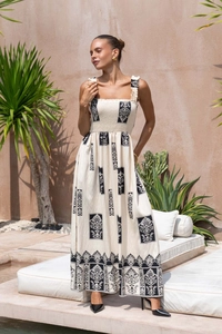 Detail of printed maxi dress showing high-waisted pleats and vintage print texture