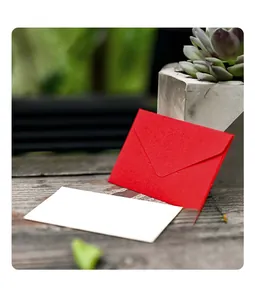 Close-up of a red textured specialty paper mini envelope with a white card insert