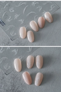 Macro shot of S-769 white abstract curves and dots nail art decals on nude pink nails