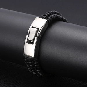 Close-up of men's black braided leather bracelet with a silver stainless steel clasp