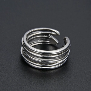 Minimalist silver multilayer open ring with adjustable design on dark textured background