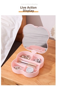 Pink clover-shaped jewelry box with built-in makeup mirror and multi-grid storage layout