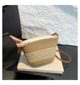 Detailed straw bucket bag with brown and white stripes and durable PU leather strap