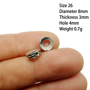 Macro shot of 8mm hollow silver spacer bead showing 4mm hole diameter for DIY jewelry
