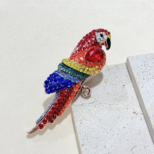 Vintage parrot brooch with colorful rhinestones on beige stone, rose gold animal accessory