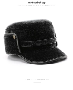 Close-up of black winter faux mink fur hat with leather brim and warm ear flaps