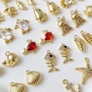14k gold plated marine pendants featuring sea stars, turtles, and shells on white background
