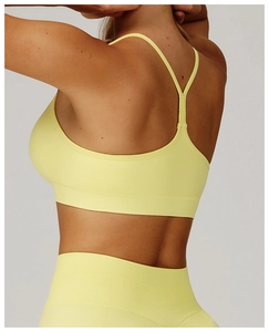 Close-up of bright yellow seamless sports bra with Y-back straps and ribbed texture