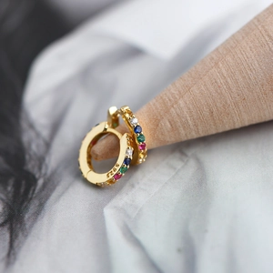 Macro shot of S925 sterling silver hoop earrings with vibrant colorful cubic zirconia