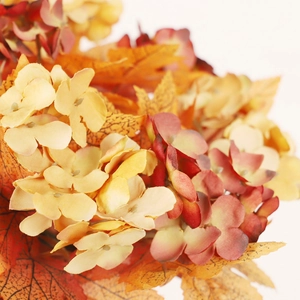 Autumn candle ring wreath with orange maple leaves and yellow hydrangea flowers