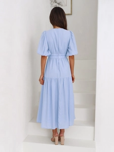 Rear view of light blue puff sleeve dress showing back zipper and waistline details