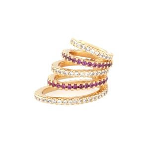 Detail of gold spiral ear cuff featuring inlaid clear and purple zircon stones