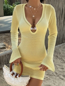 Pale yellow Y2K knit mini dress with deep V-neck and flared sleeves on a beach model