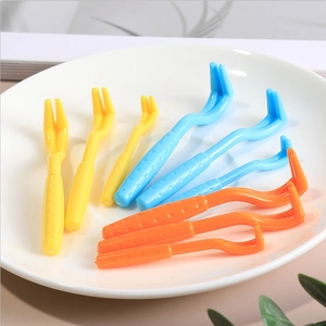Set of 3 plastic pet tick removers in yellow, blue and orange on a clean white tray