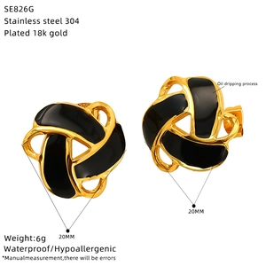 Detail view of 20mm knot earrings in 18k gold plated steel with black enamel finish