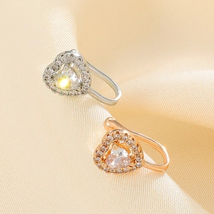 Minimalist heart zircon nose clips in silver and rose gold on silk background