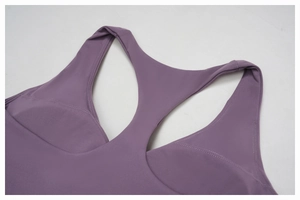 Close-up of deep purple racerback yoga top showing high-density knit fabric and stitching