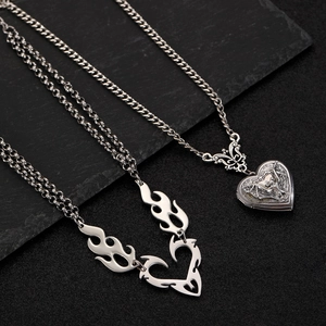 Silver vintage heart locket and punk hollow flame heart pendant necklace set on dark stone