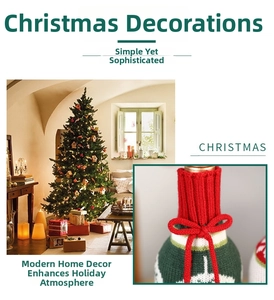 Detail of knitted Christmas wine bottle cover with red bow and festive green stripes