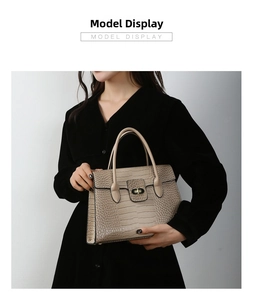 Detail of apricot crocodile pattern handbag with elegant metal twist lock and dual handles