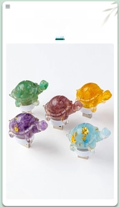 Close-up of assorted crystal resin turtle night lights with gold foil and USB bases