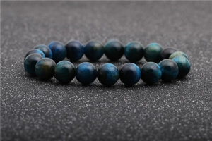 Macro close-up of blue tiger eye stone beads on a premium beaded bracelet for men