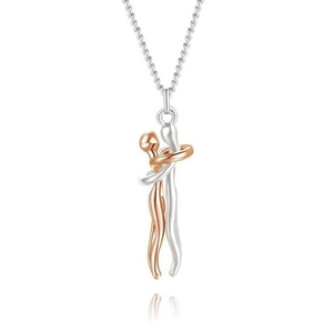 Two-tone hug necklace pendant in rose gold and silver finish with elegant studio reflection