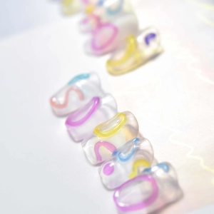 Macro view of jelly nail stickers with 3D embossed colorful letters and resin texture
