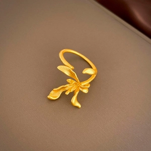 Macro shot of matte gold orchid ring showing exquisite sandblasted metal petals