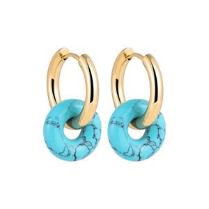 Close-up of 18K gold earrings featuring natural green turquoise ring-shaped pendants