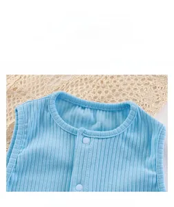 Detail of light blue baby romper featuring ribbed cotton fabric and snap button closure