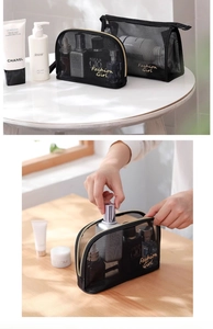 Detail of black mesh makeup bags in two sizes with gold Fashion Girl lettering print