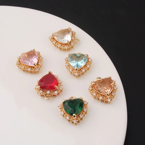 Gold-plated heart pendants with micro-set zircon in six colors on white ceramic plate