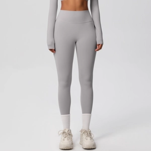 Detail of high-waist yoga leggings in grey with seamless wide waistband and elastic fabric